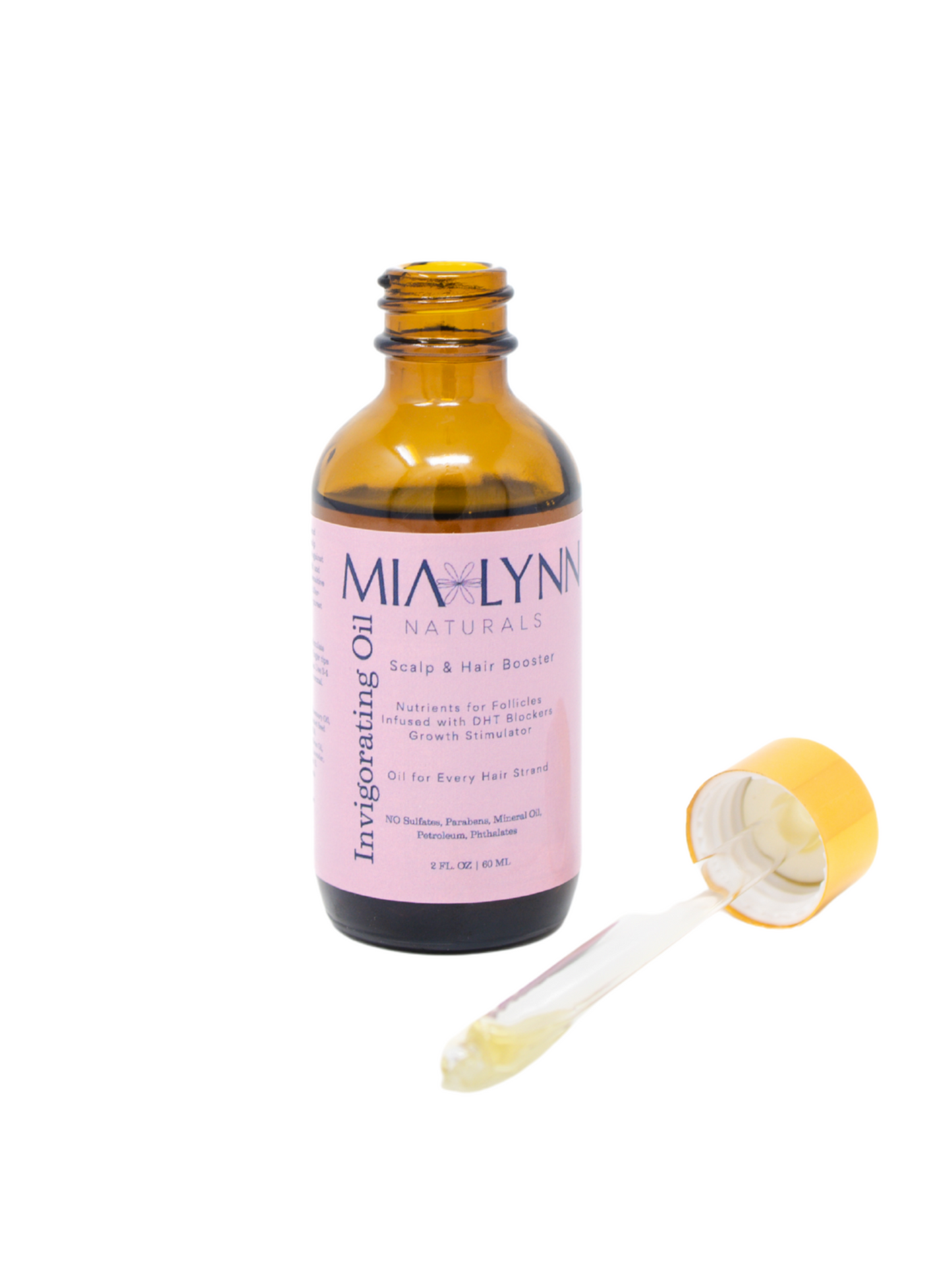 Natural hair growth oil in amber bottle with white background