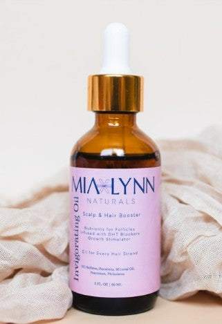 Natural hair growth oil in amber bottle with white background